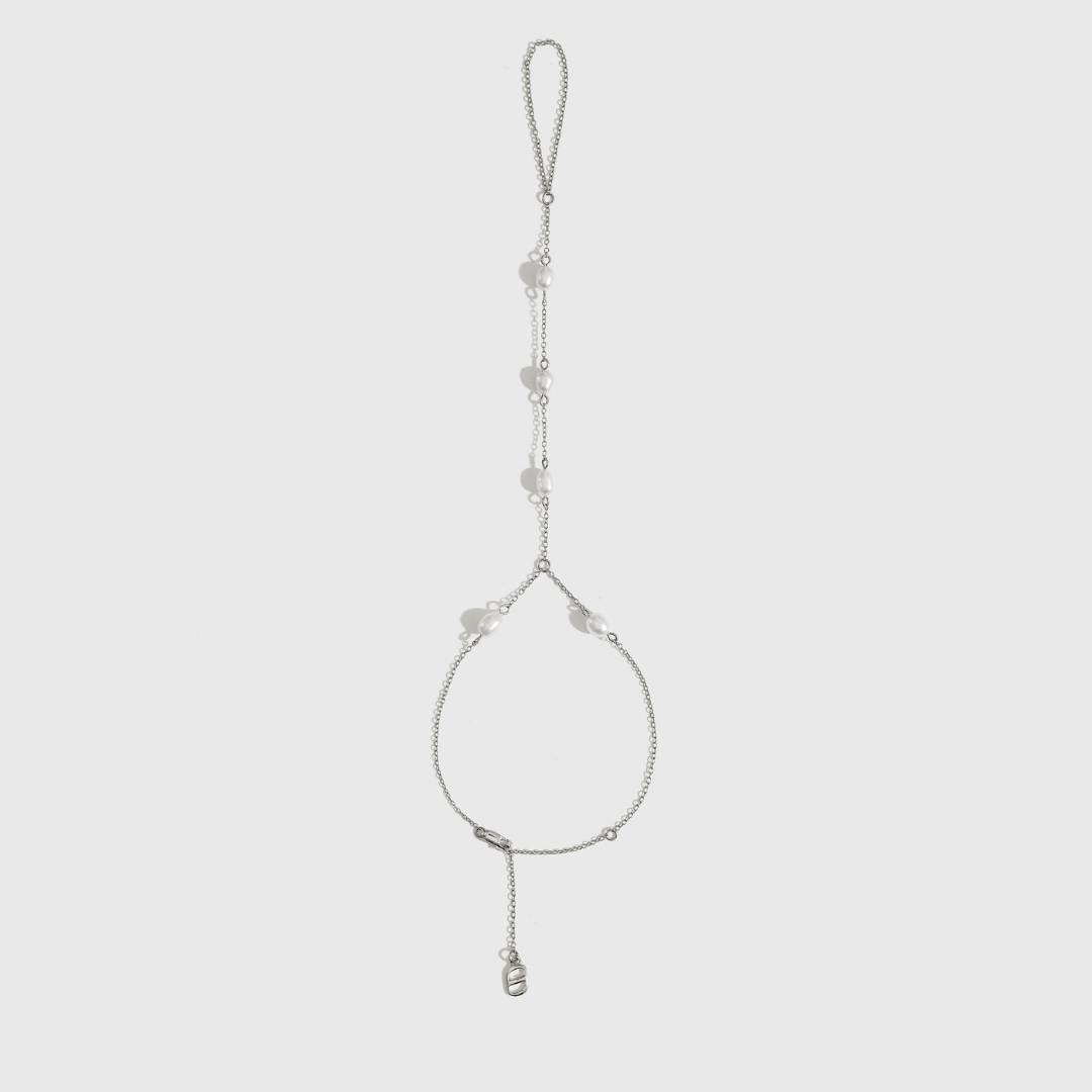 Sterling silver 925 dainty freshwater pearl hand chain with freshwater pearls, shown on a plain background.