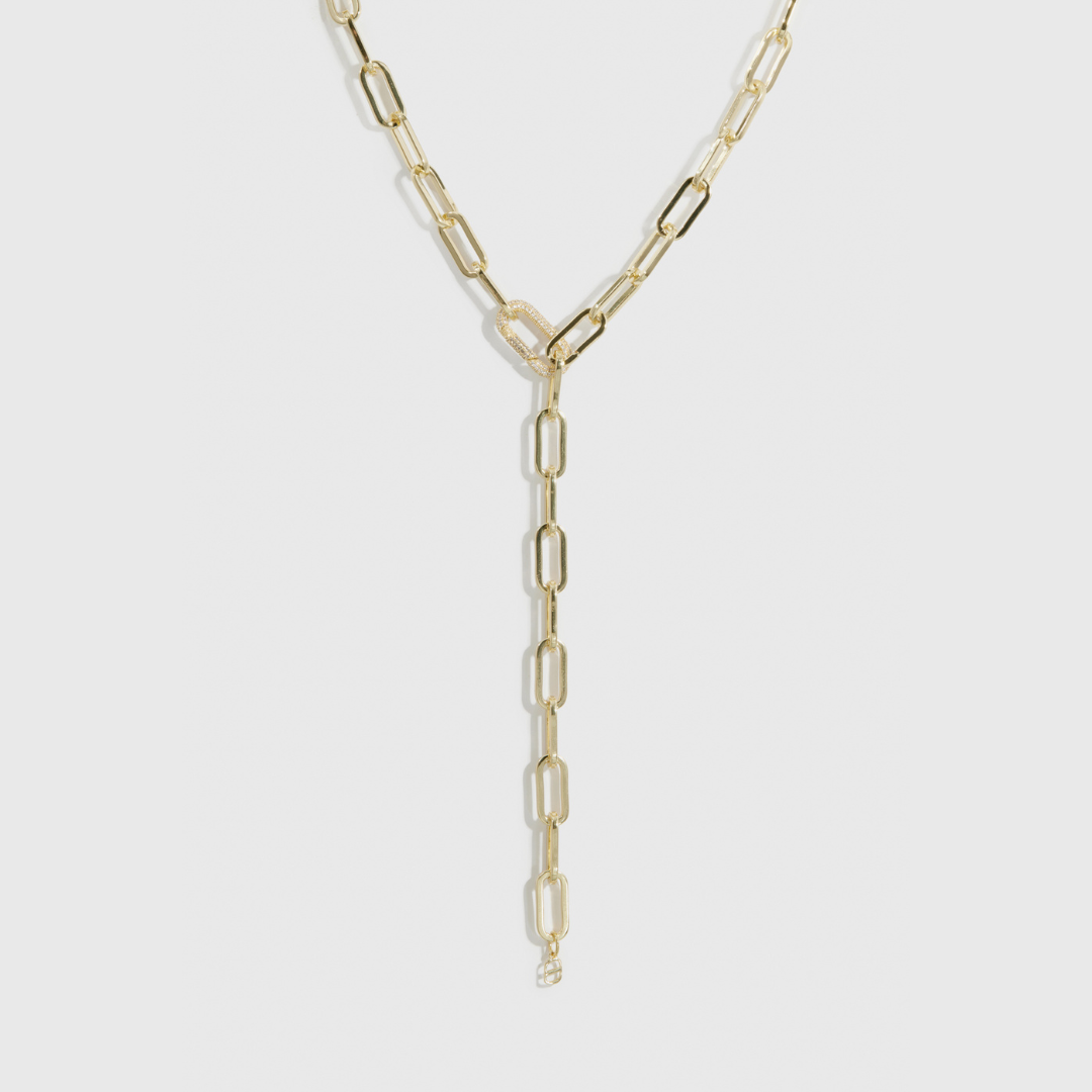 14k gold plated maximalist paper clip lariat necklace with a pavé cubic zirconia clasp, shown on a plain background.