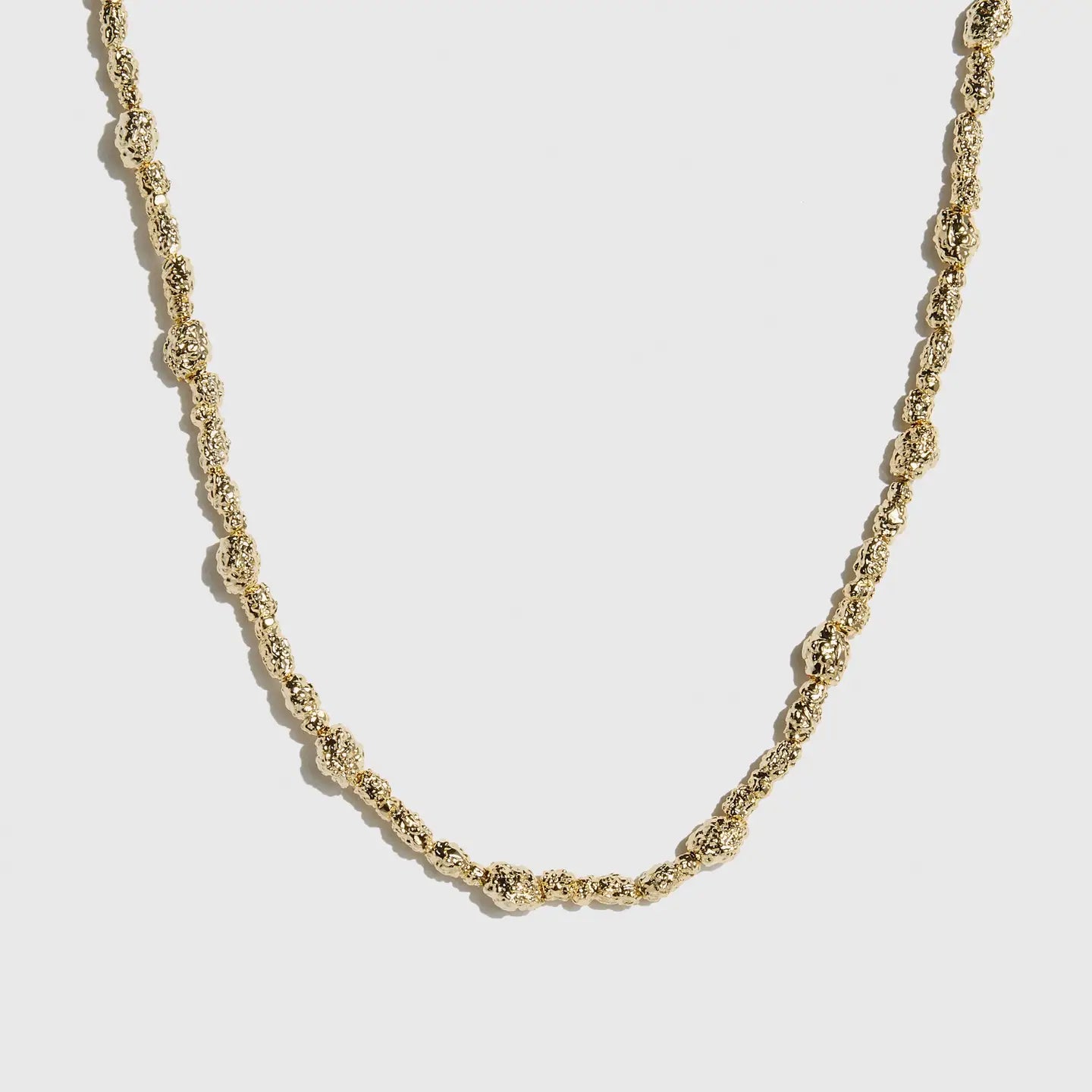 14k gold plated beaded nugget necklace with 4mm beads strung along the chain, shown on a plain background.