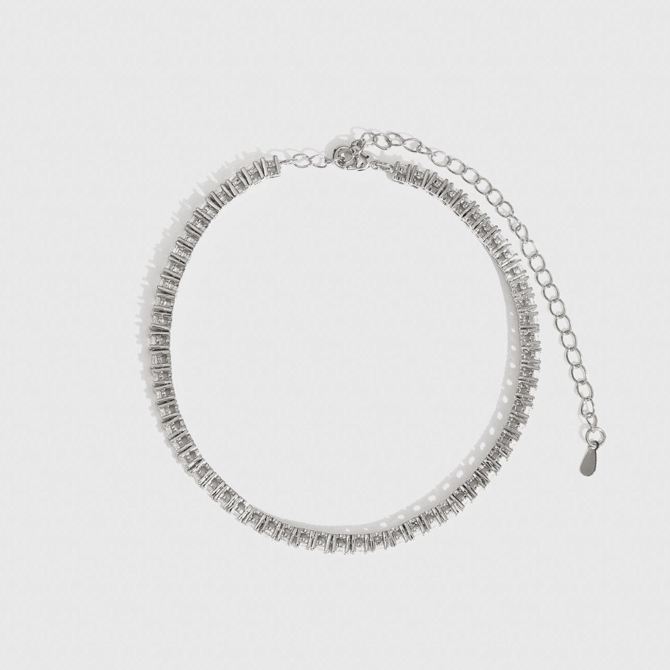 Silver plated thin tennis anklet with cubic zirconia, shown on a plain background.