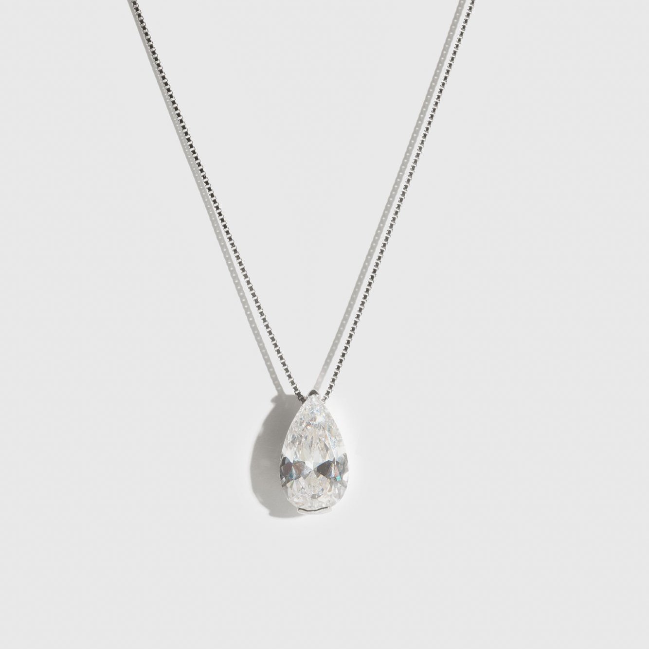 Sterling silver 925 solitaire teardrop pendant necklace with a teardrop cubic zirconia, shown on a plain background.
