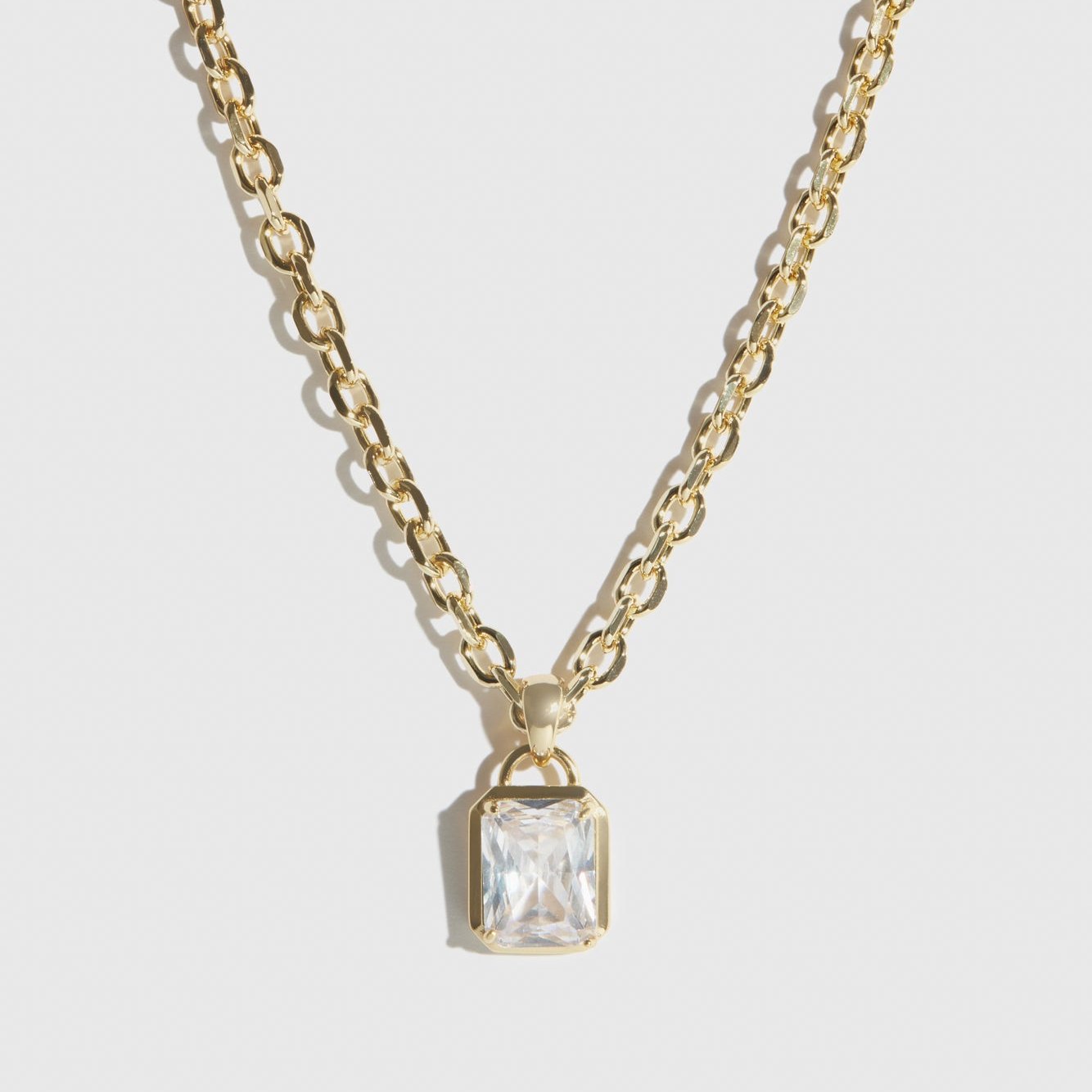 14k gold plated baguette necklace with a cubic zirconia, shown on a plain background.