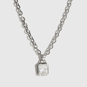 Silver plated baguette necklace with a cubic zirconia, shown on a plain background.