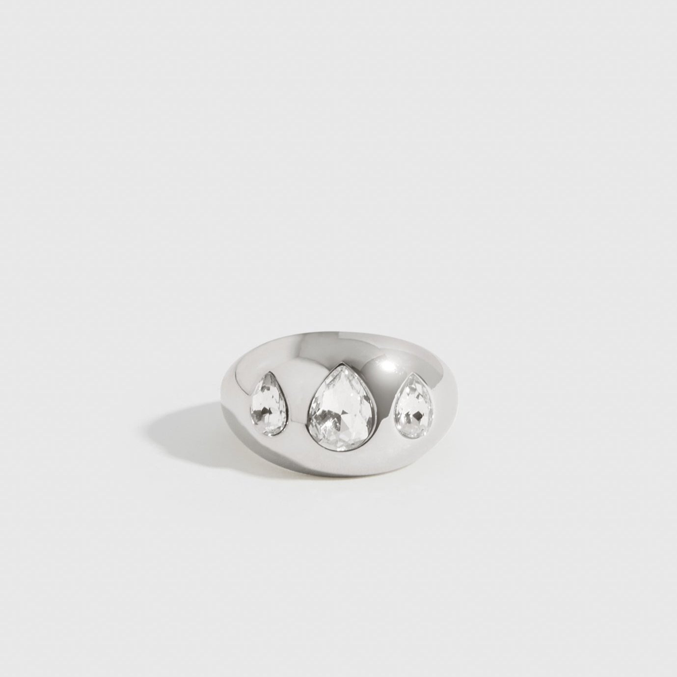 Silver plated teardrops dome ring with teardrop cubic zirconia, shown on a plain background.