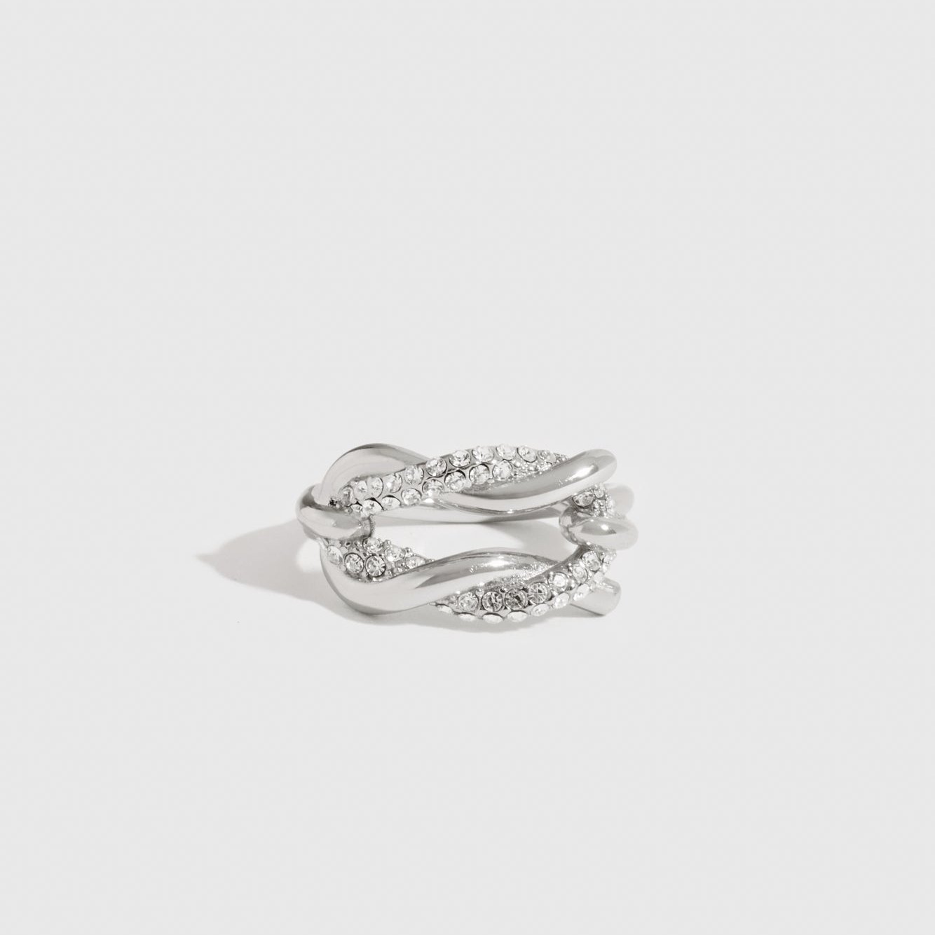 Sterling silver 925 knot pavé ring with cubic zirconia, shown on a plain background.