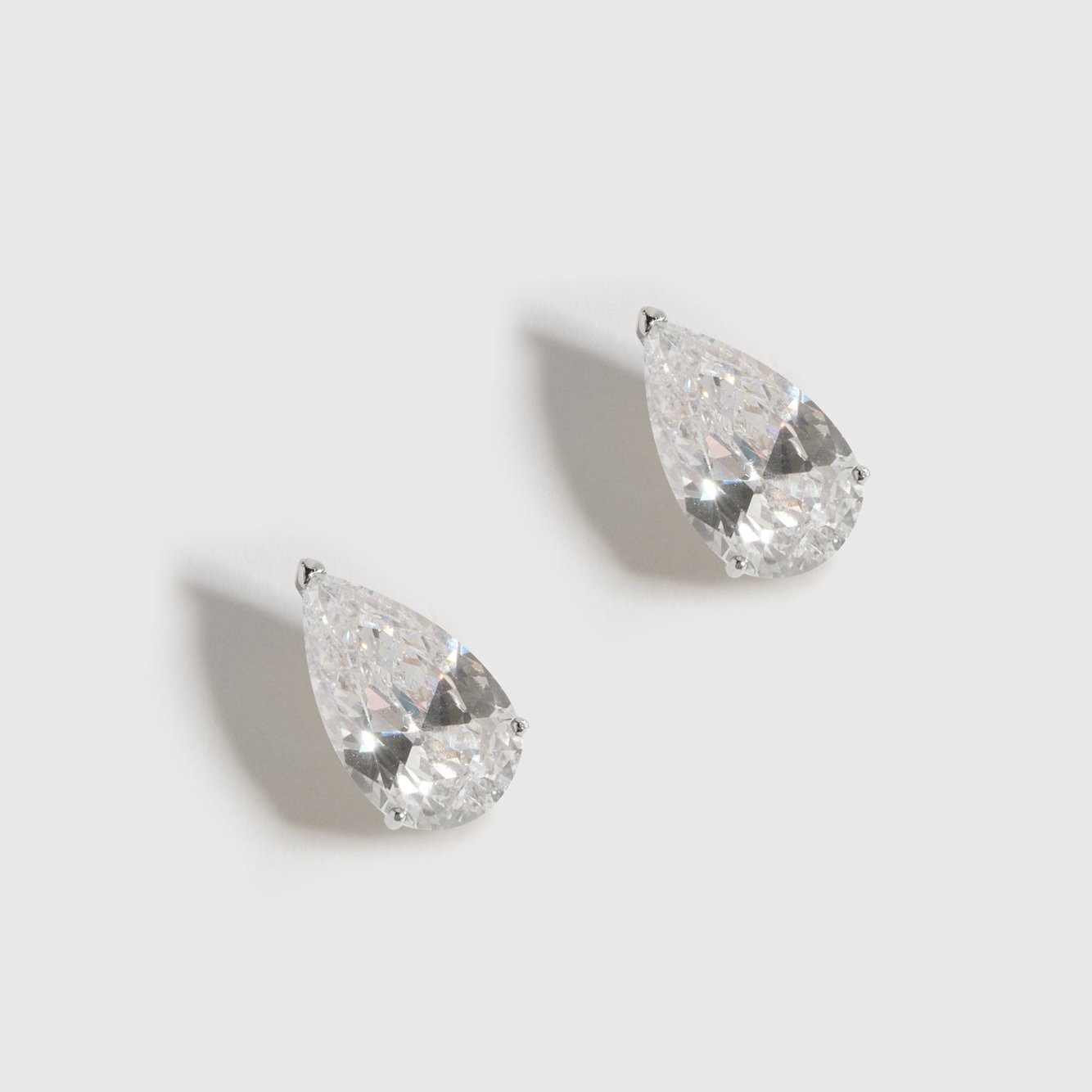Sterling silver 925 solitaire teardrop stud earrings with teardrop cubic zirconia, shown on a plain background.