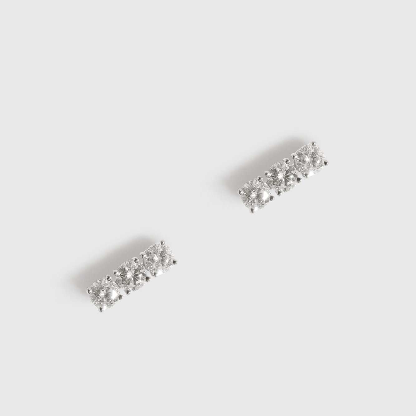 Sterling silver 925 ear bar stud with three cubic zirconia, shown on a plain background.