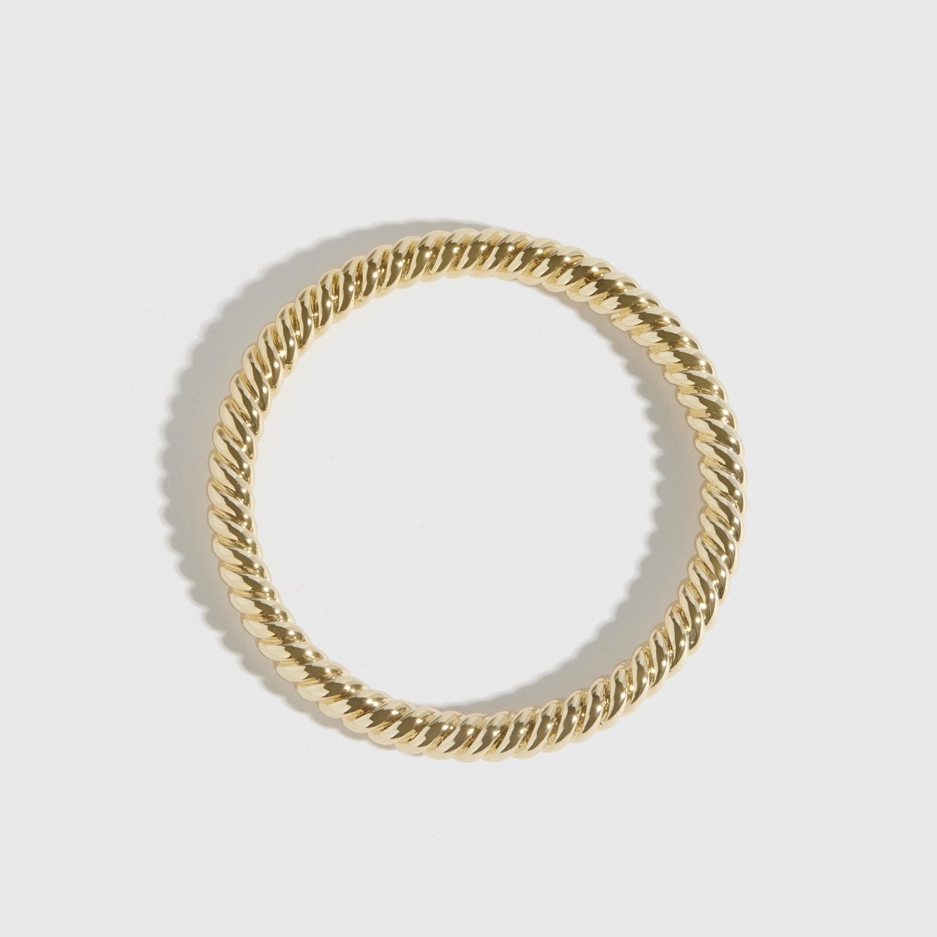 14k gold plated braided bangle, shown on a plain background.