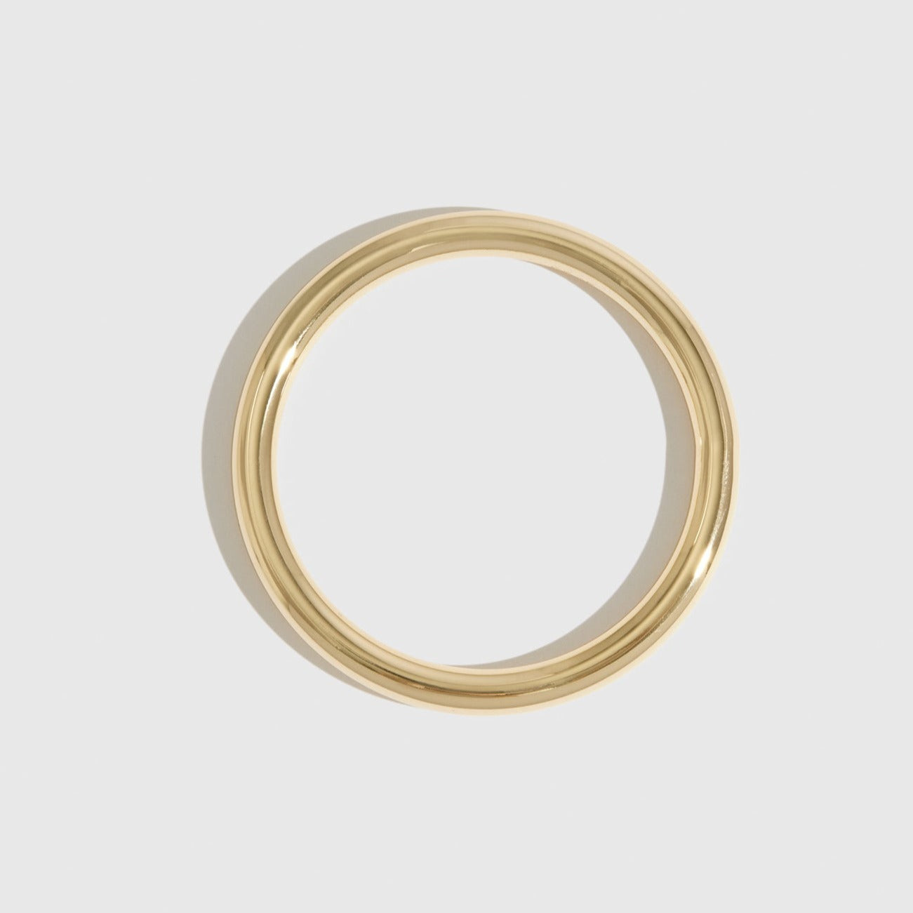 14k gold plated stackable bangle, shown on a plain background.