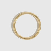 14k gold plated stackable bangle, shown on a plain background.