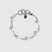 Sterling silver 925 paper clips and pearls bracelet with freshwater pearls, shown on a plain background.