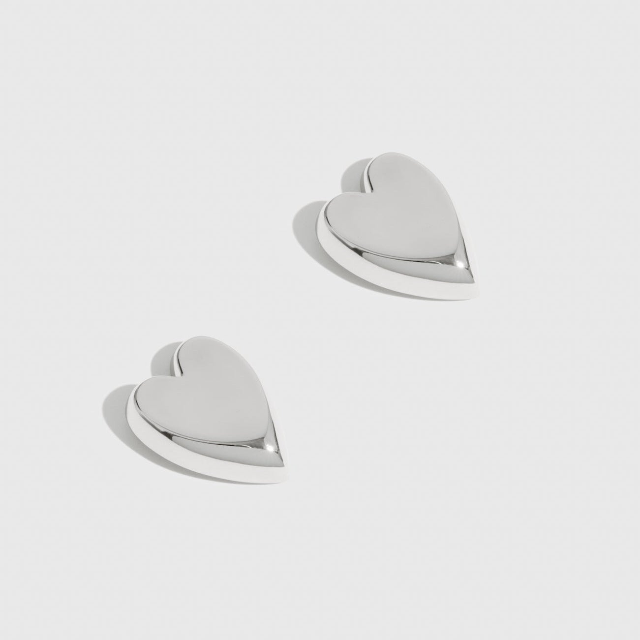 Silver plated heart stud earrings, shown on a plain background.