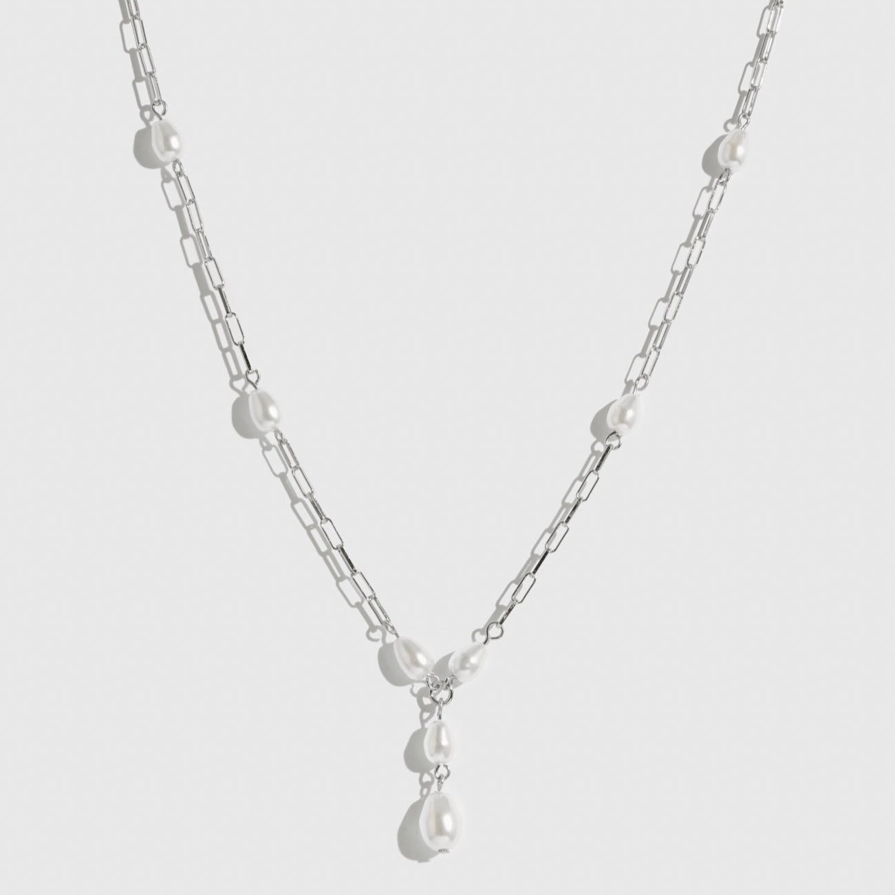 Sterling silver 925 paper clips and pearls necklace with freshwater pearls, shown on a plain background.