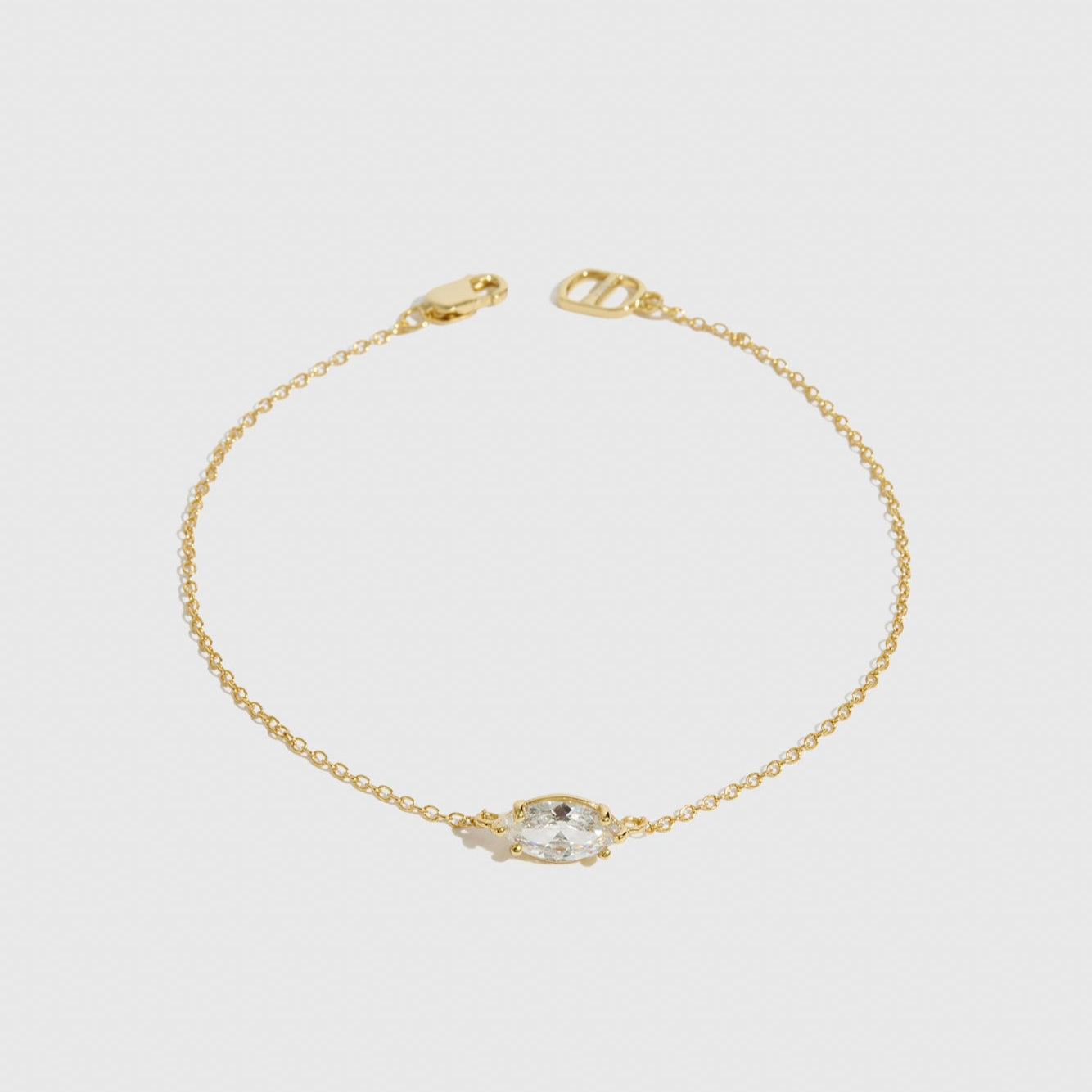 14k gold plated sterling silver 925 marquise-cut solitaire bracelet with a pure white cubic zirconia, shown on a plain background.