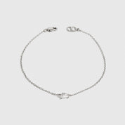 Sterling silver 925 mini teardrop-cut solitaire bracelet with a pure white cubic zirconia, shown on a plain background.