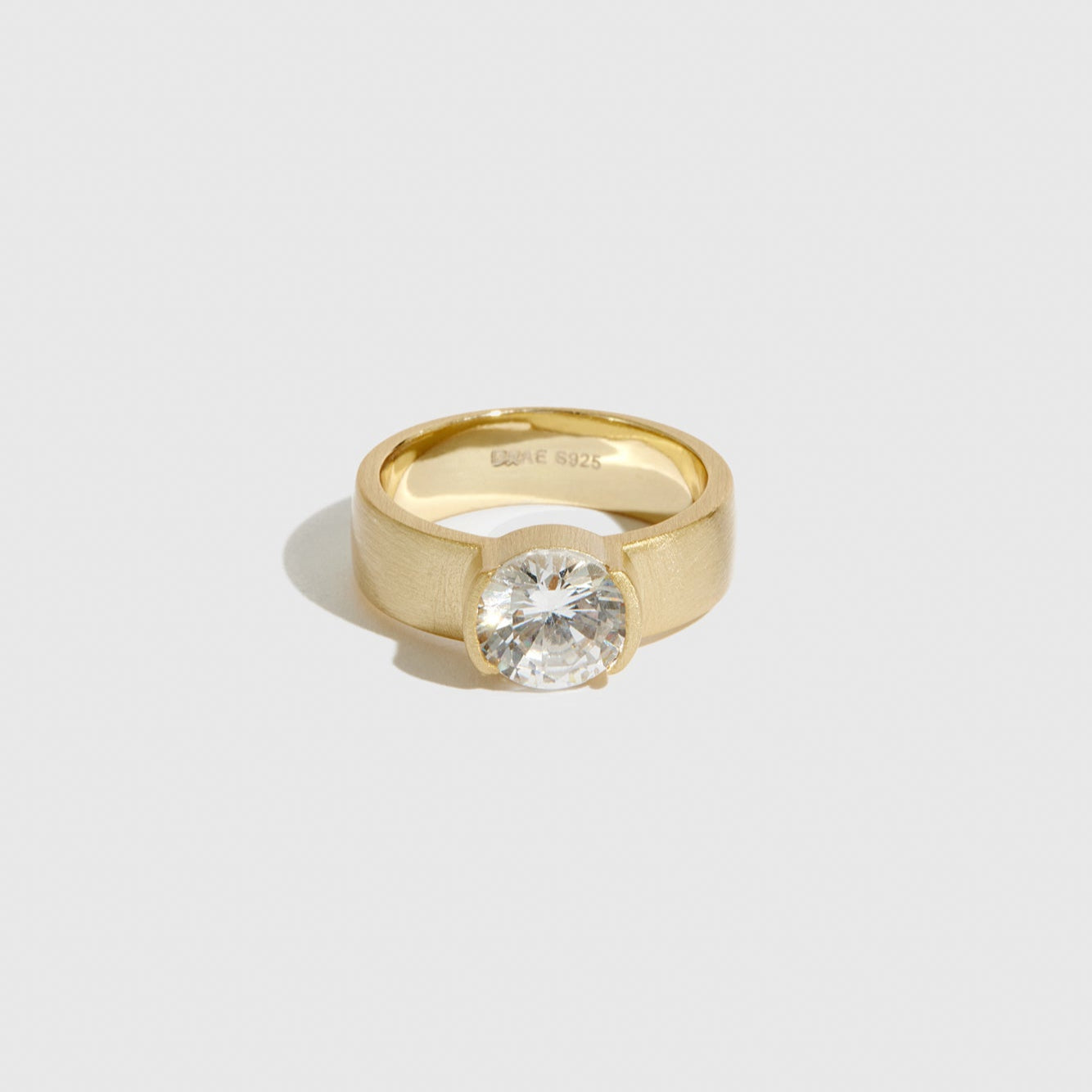 14k gold plated sterling silver 925 chunky round-cut solitaire ring with a round-cut cubic zirconia, shown on a plain background.