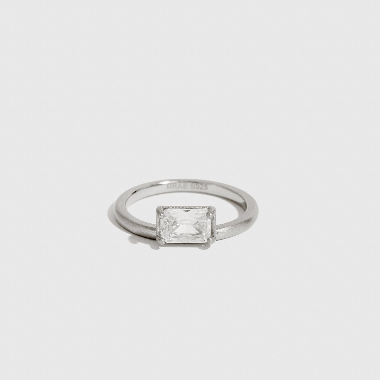 Sterling silver 925 baguette-cut solitaire ring with a baguette-cut cubic zirconia, shown on a plain background.