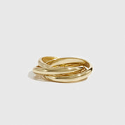 Three gold rings stacked on a light gray background