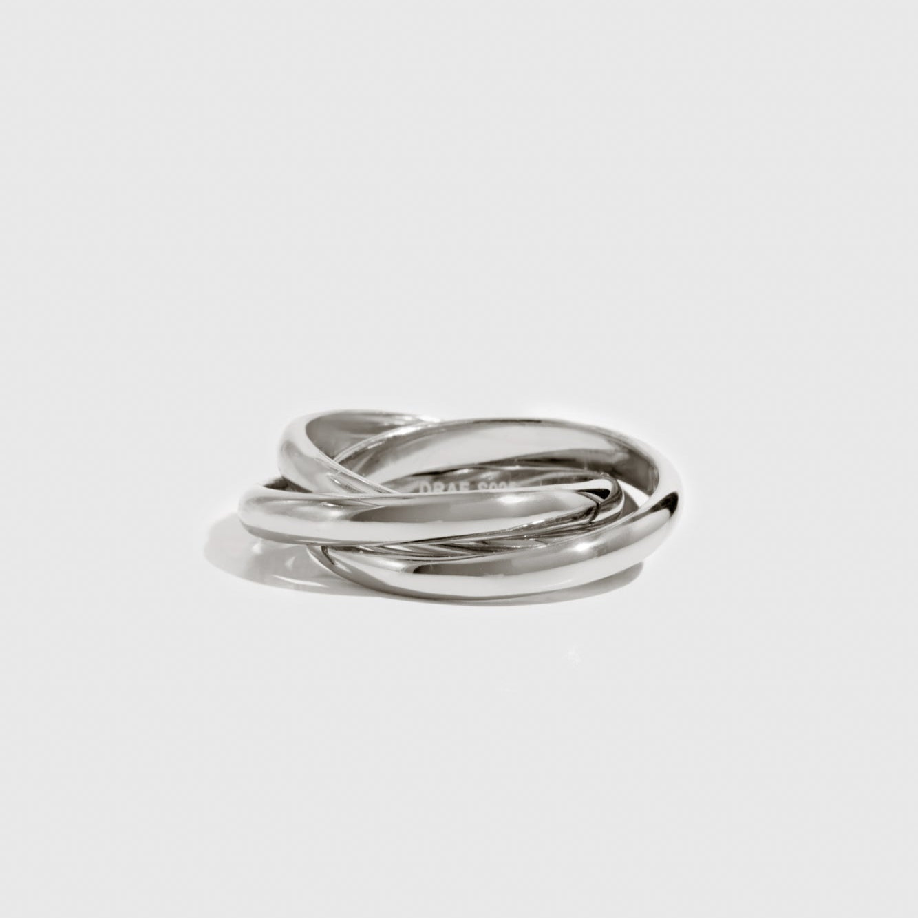 Silver ring on a light gray background