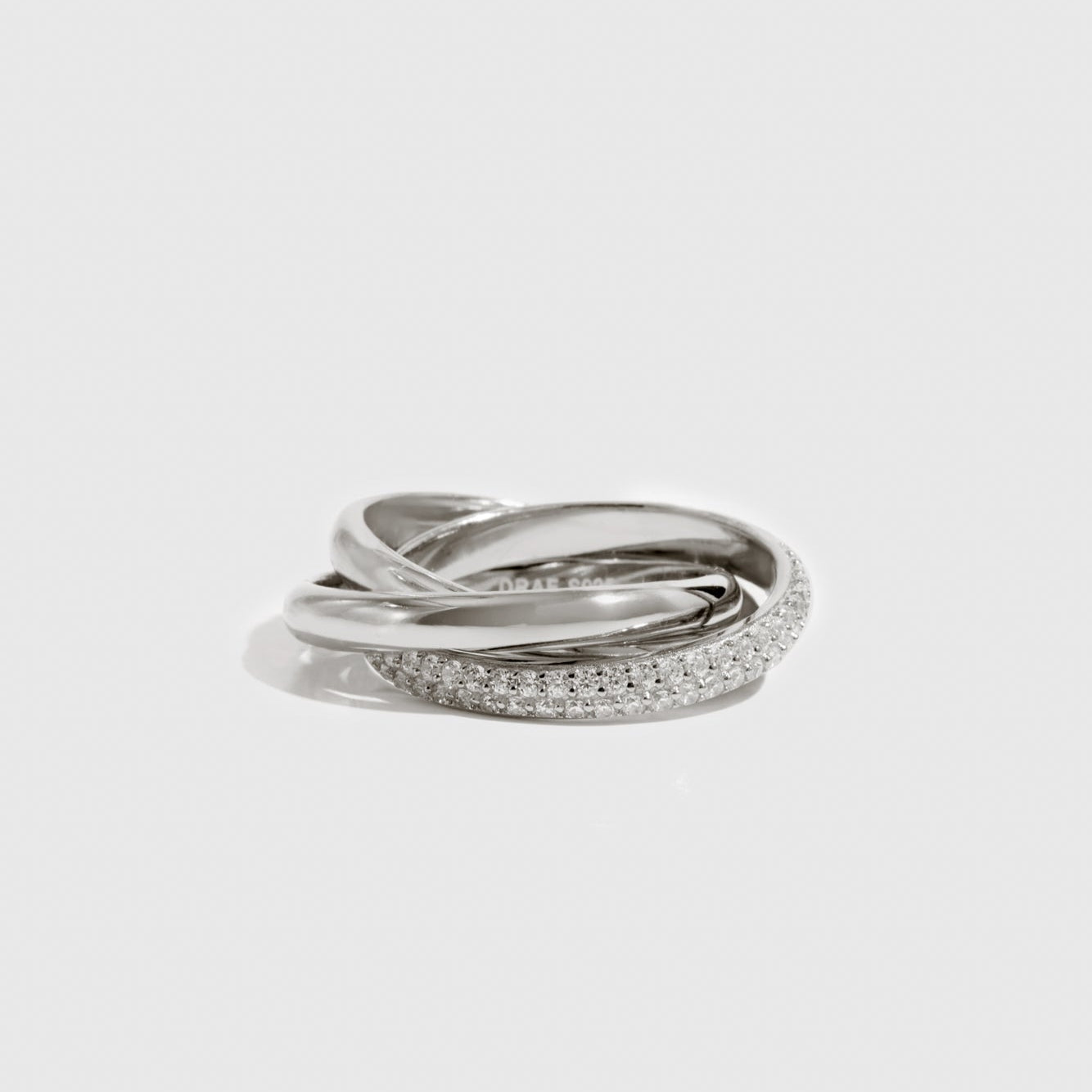 Sterling silver 925 eternal trio pavé ring with cubic zirconia, shown on a plain background.