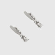 Sterling silver 925 mini teardrop-cut solitaire huggies with a pure white cubic zirconia, shown on a plain background.