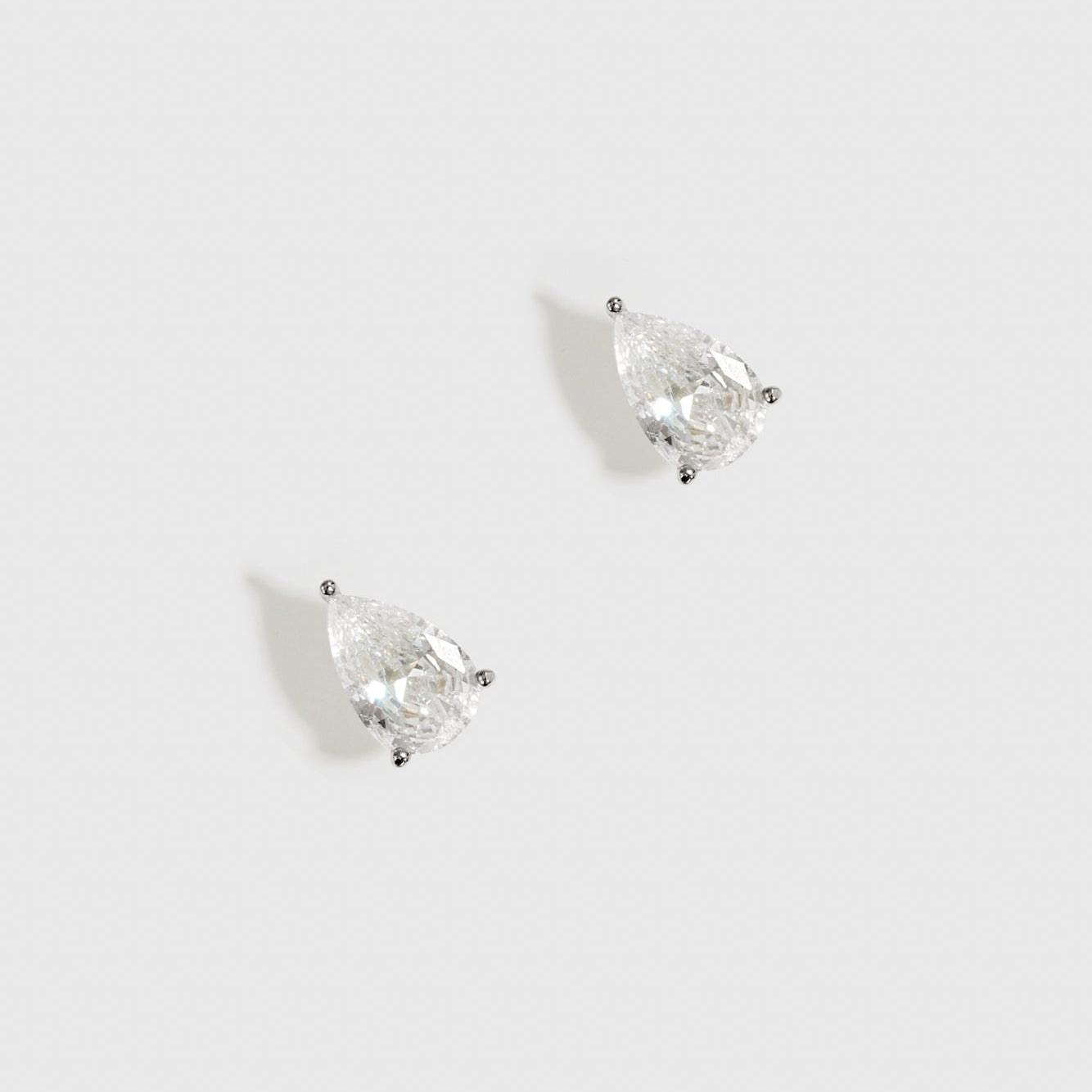 Sterling silver 925 regular teardrop-cut solitaire stud earrings with a pure white cubic zirconia, shown on a plain background.