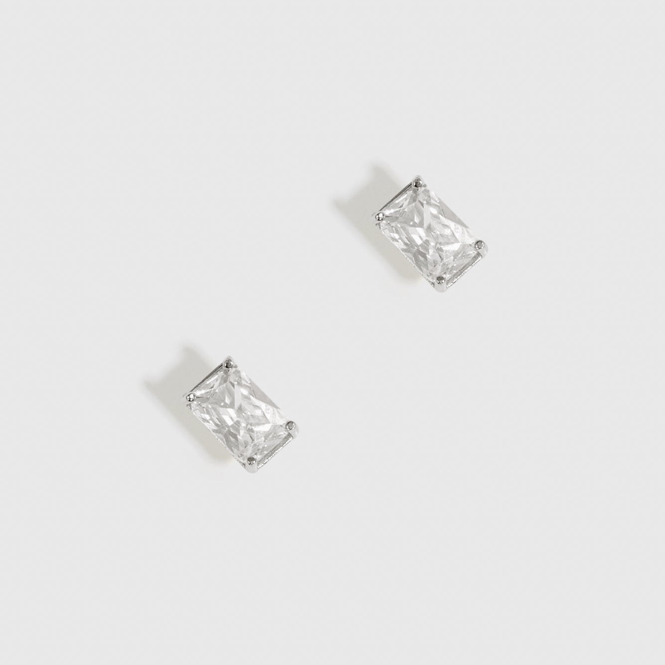 Sterling silver 925 baguette-cut solitaire stud earrings with a pure white cubic zirconia, shown on a plain background.