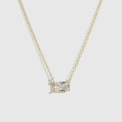 14k gold plated sterling silver 925 baguette-cut solitaire necklace with a pure white cubic zirconia, shown on a plain background.