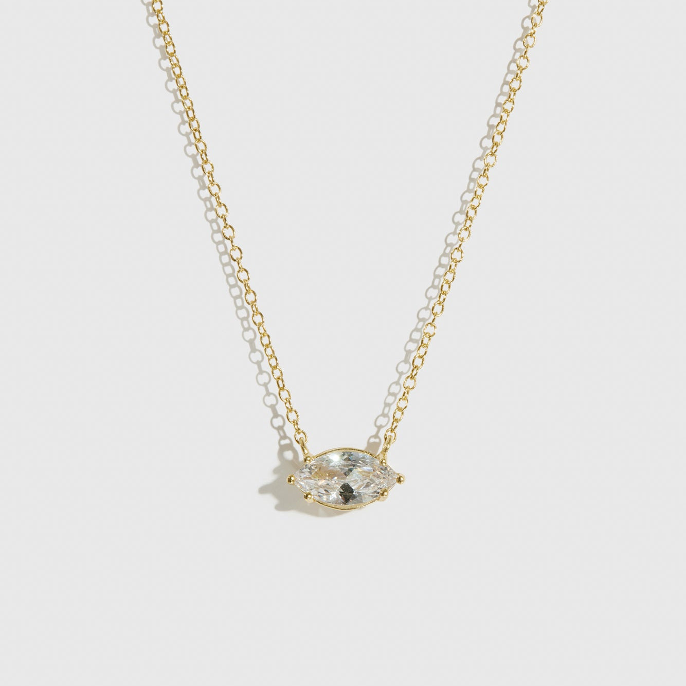14k gold plated sterling silver 925 marquise-cut solitaire necklace with a pure white cubic zirconia, shown on a plain background.