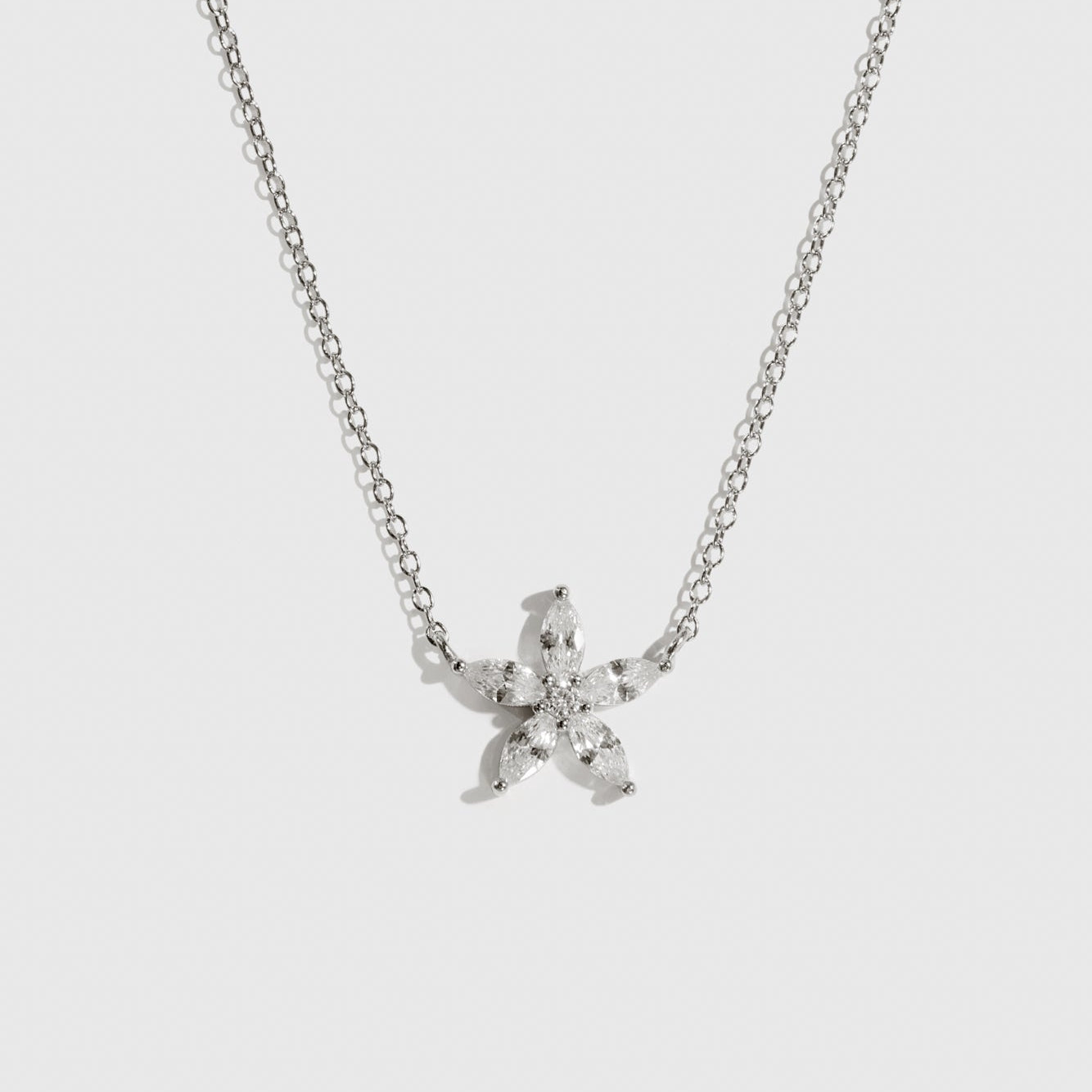 Sterling silver 925 flower solitaire necklace with a pure white cubic zirconia, shown on a plain background.