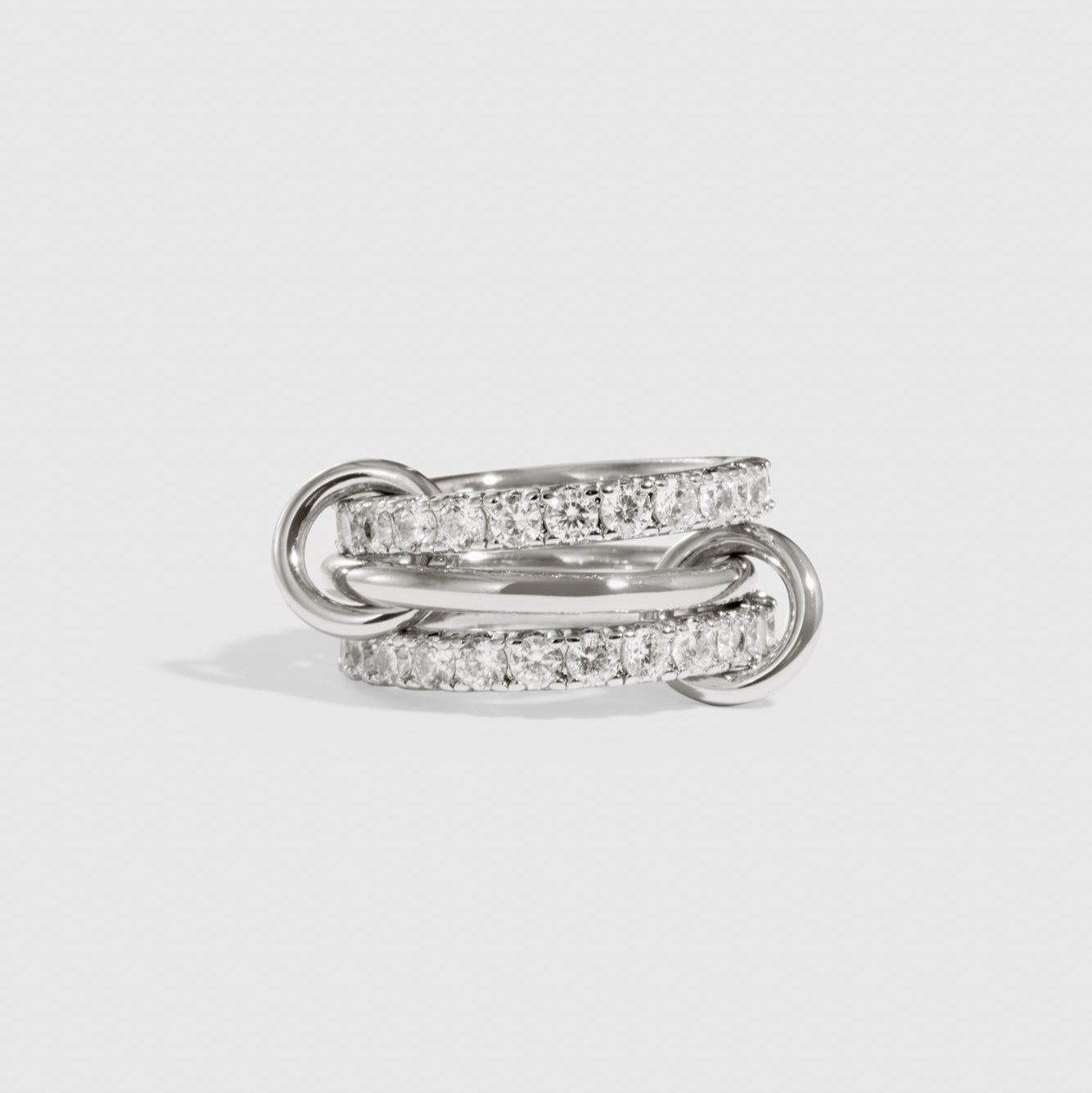 Silver plated quintuplet interlocking bare links ring with cubic zirconia, shown on a plain background.