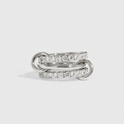 Silver plated quintuplet interlocking bare links ring with cubic zirconia, shown on a plain background.
