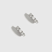 Sterling silver 925 mini pavé huggie earrings with pavé cubic zirconia, shown on a plain background.