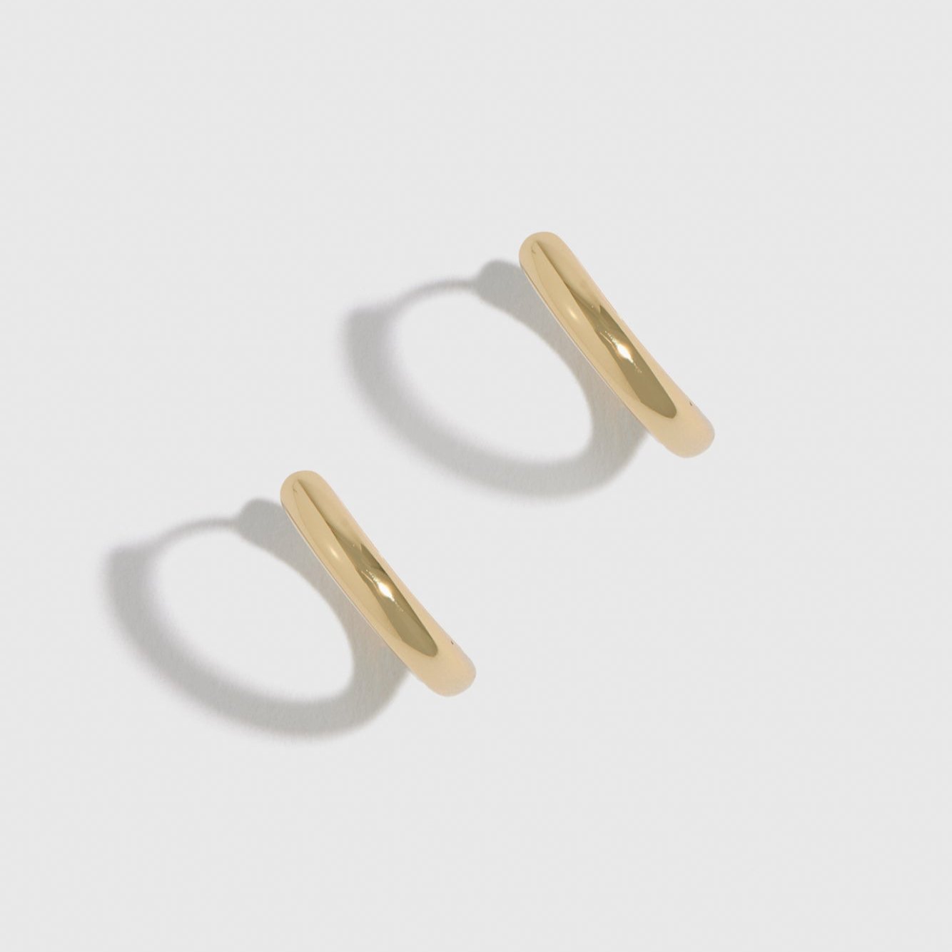 14k gold plated sterling silver 925 classic plain huggie earrings, shown on a plain background.