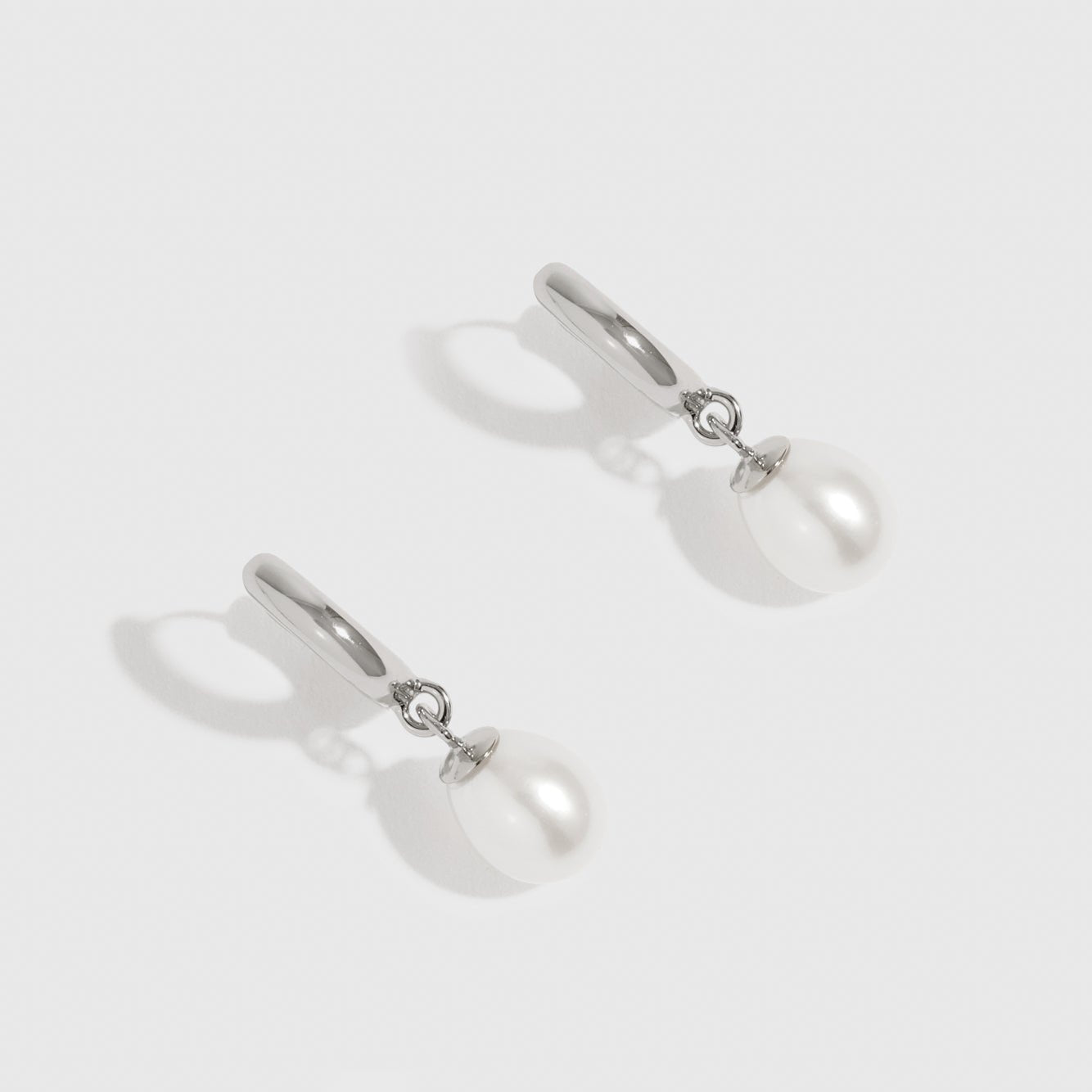 Sterling silver 925 freshwater pearl huggie earrings with freshwater pearls, shown on a plain background.