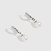 Sterling silver 925 freshwater pearl huggie earrings with freshwater pearls, shown on a plain background.