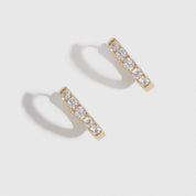 14k gold plated sterling silver 925 classic pavé huggie earrings with pavé cubic zirconia, shown on a plain background.