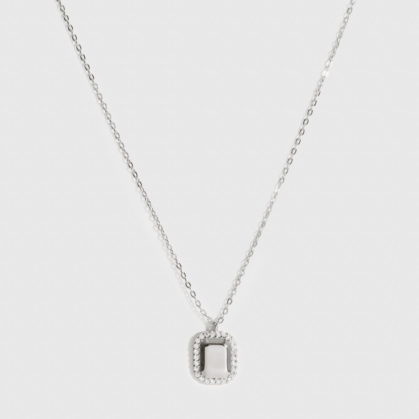 Sterling silver 925 dainty dog tag pendant necklace with cubic zirconia, shown on a plain background.