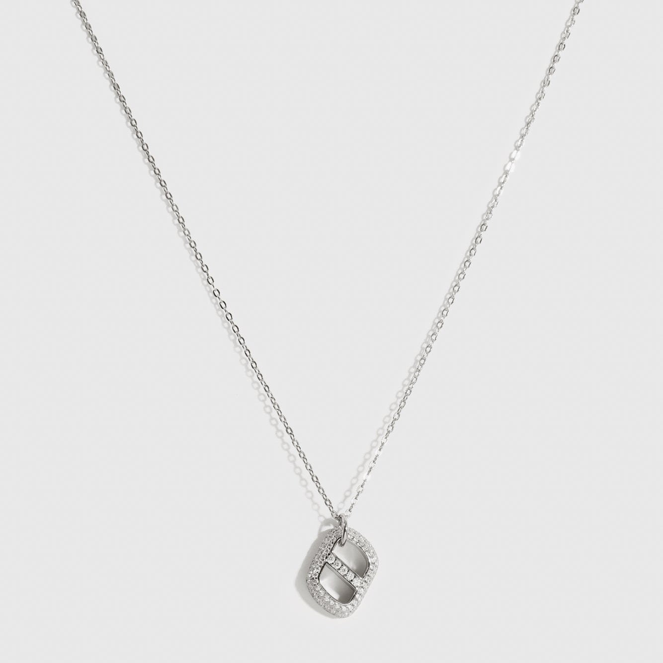 Sterling silver 925 pavé monogram pendant necklace with cubic zirconia, shown on a plain background.