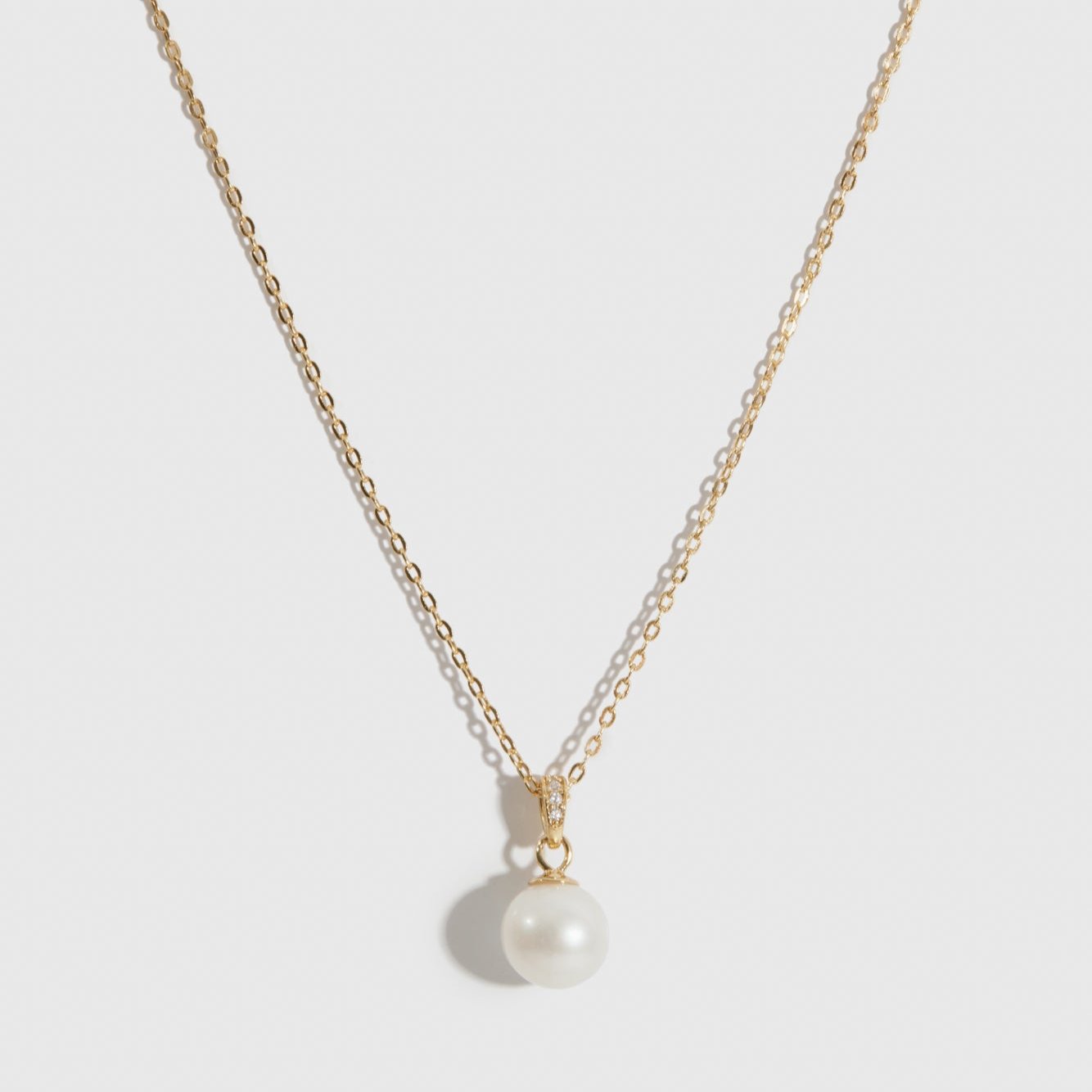14k gold plated sterling silver 925 solitaire pearl pendant necklace with a cultured freshwater pearl, shown on a plain background.