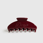 Cherry red acetate hair claw, shown on a plain background.