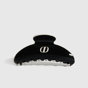 Black acetate hair claw, shown on a plain background.