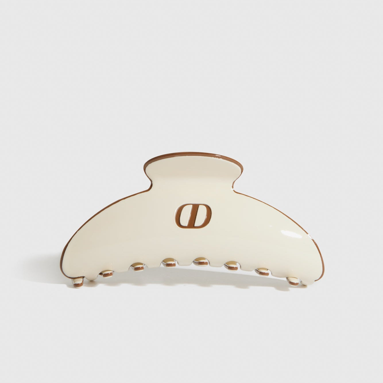 Beige acetate hair claw, shown on a plain background.