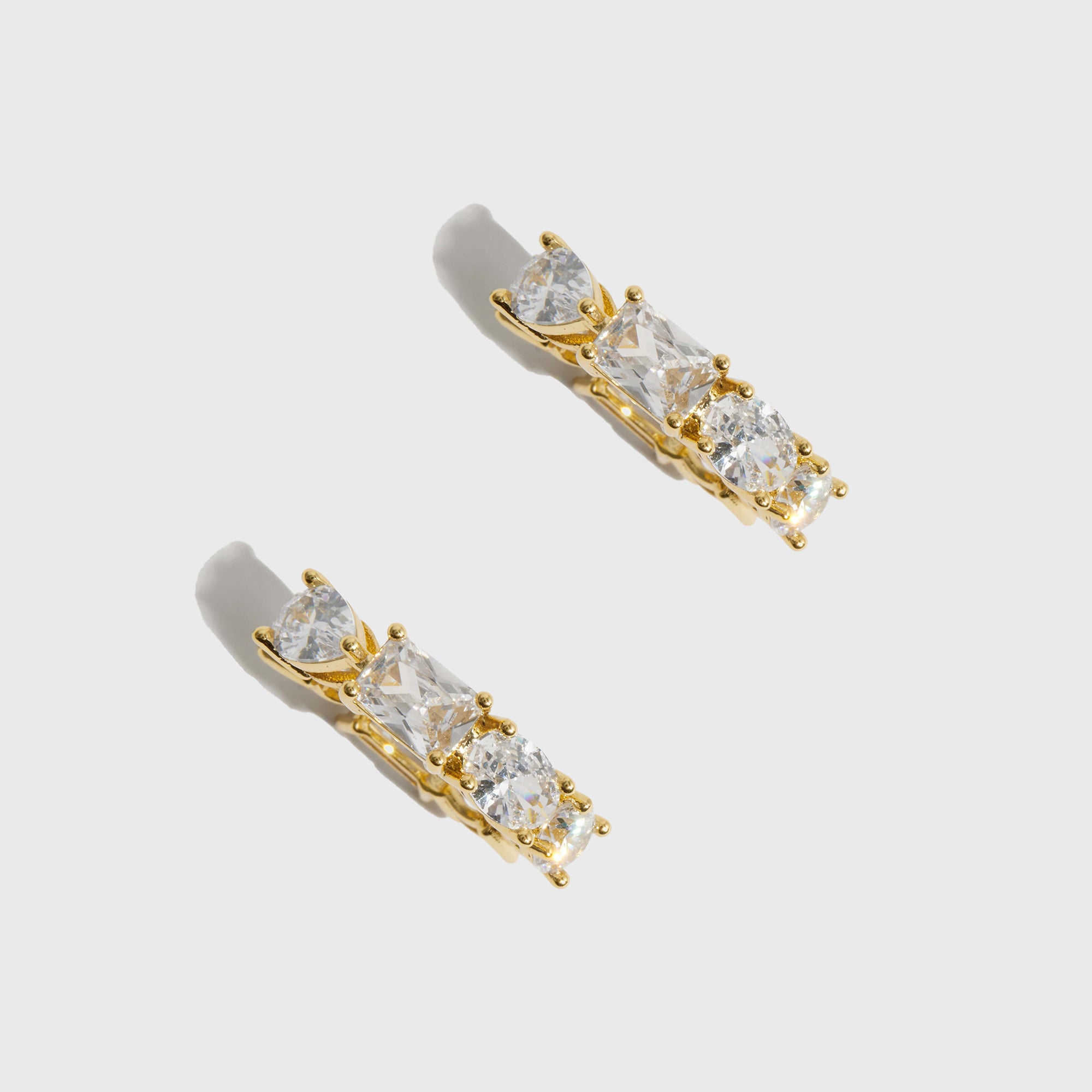 14k gold plated sterling silver 925 Ophélie hoop earrings with four cuts of cubic zirconia, shown on a plain background.