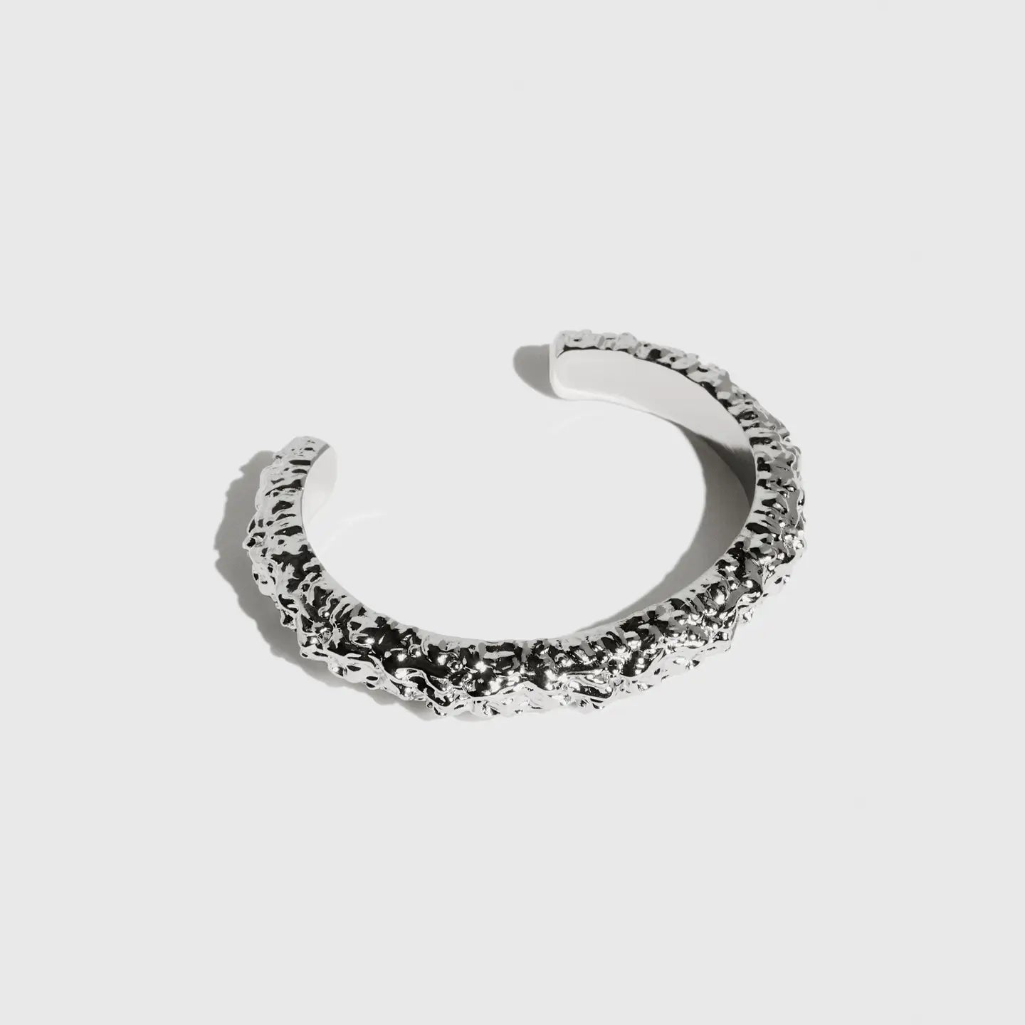 Silver thin nugget cuff bracelet with a textured finish, shown on a plain background.