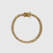 14k gold plated sterling silver 925 round bezel tennis bracelet with round-cut cubic zirconia, shown on a plain background.