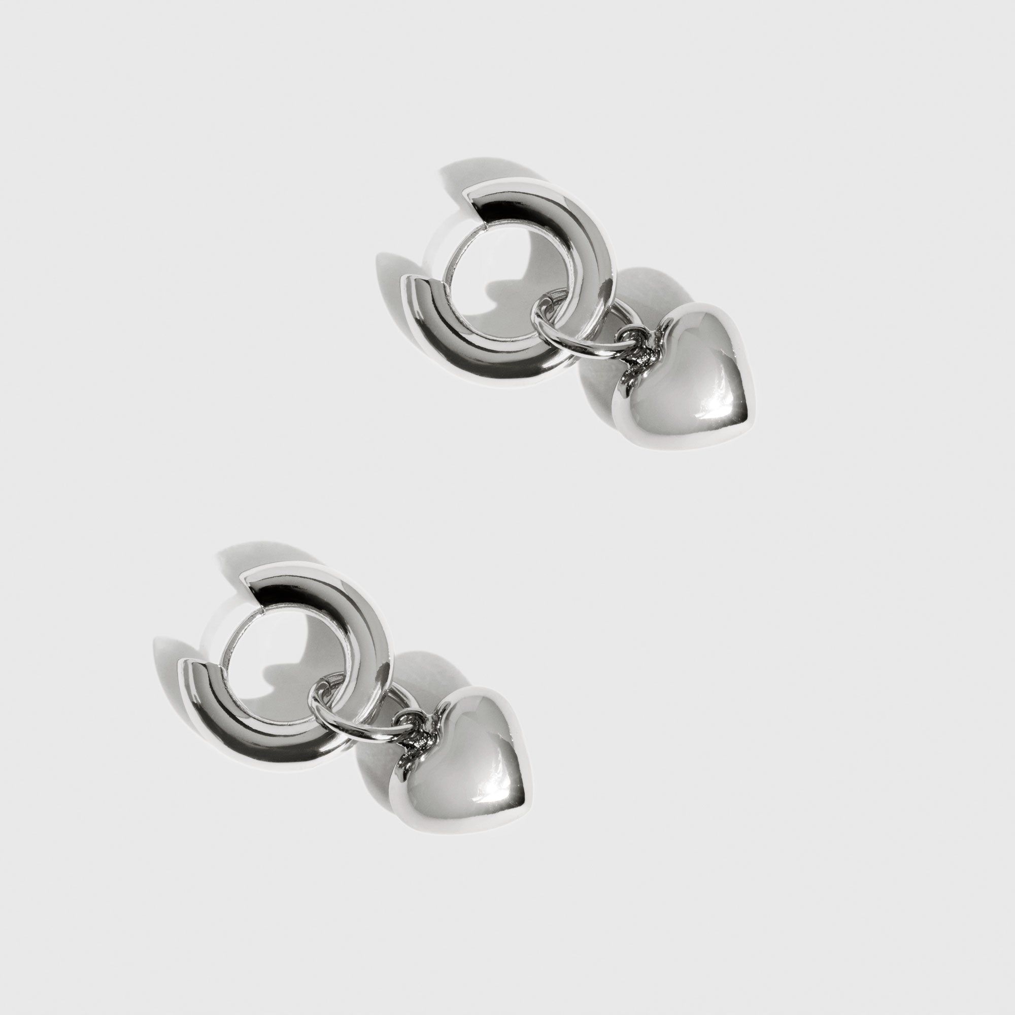 Silver plated Twin Flames hoop earrings, shown on a plain background.